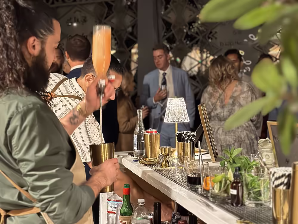Bartender pouring cocktails for guests at an evening corporate event